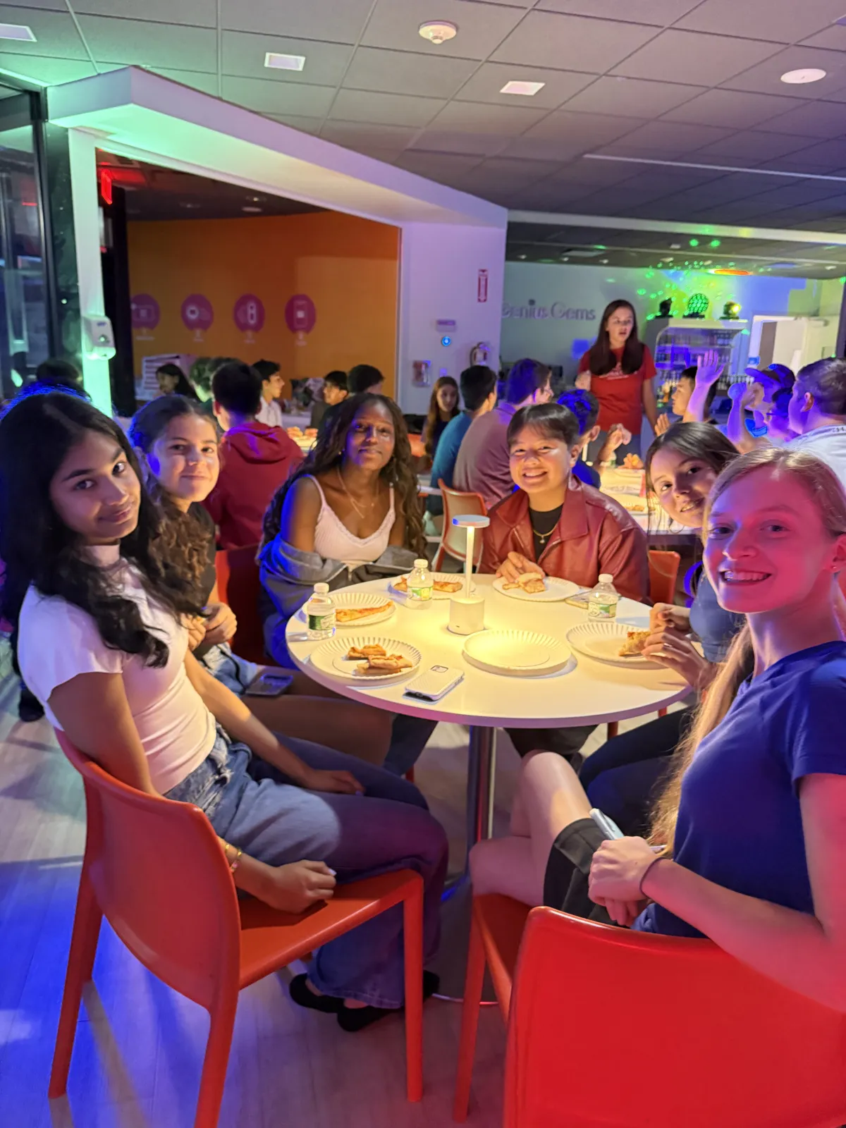 Friends at a table during an After Dark night in Millburn